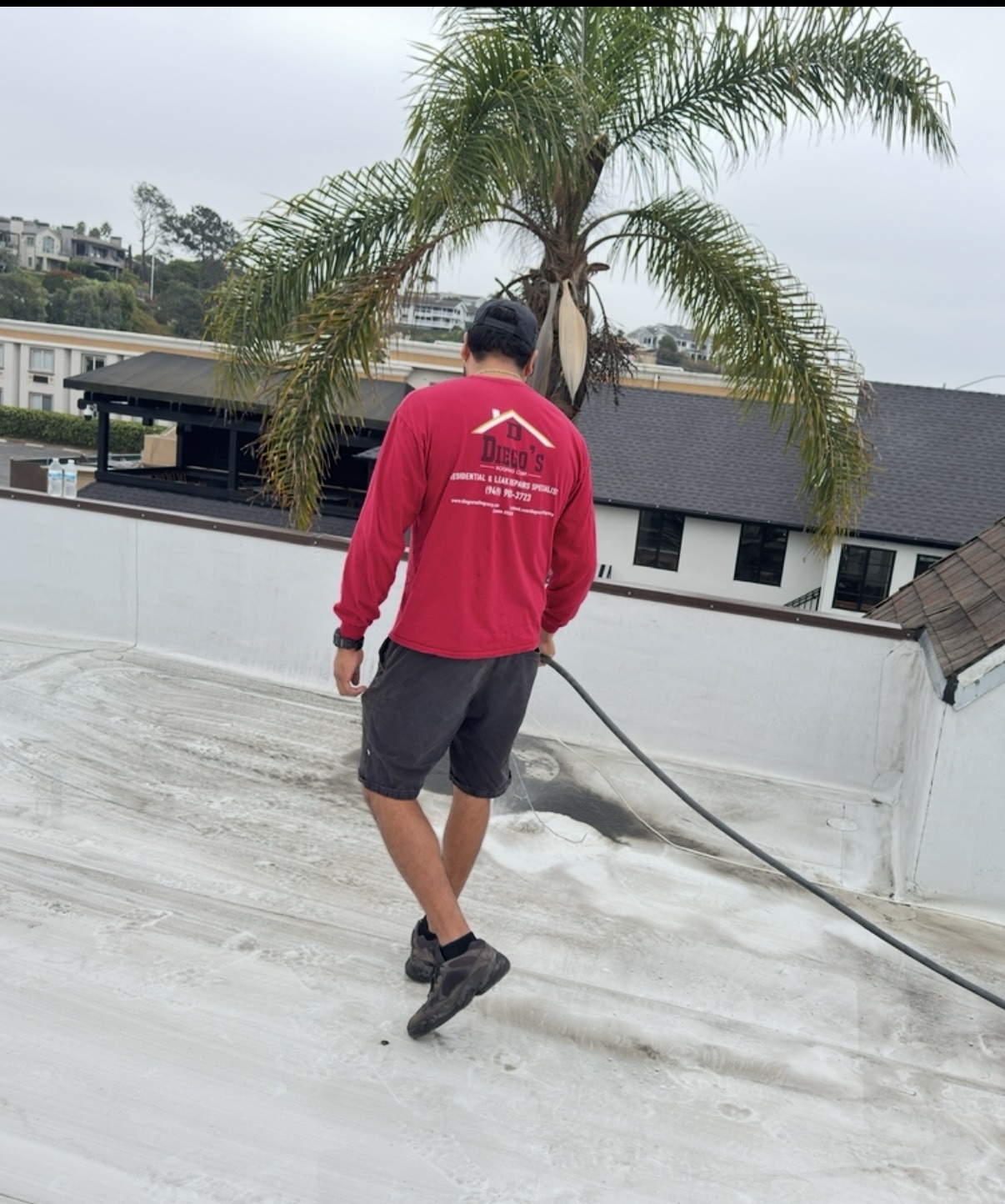 Roof Washing Services Roof washing crew at work for Diego's Roofing Corp